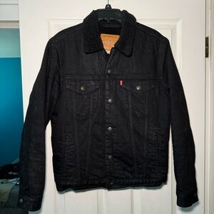 Levi’s Black Denim Sherpa Trucker Jacket marked as a Men’s Medium
